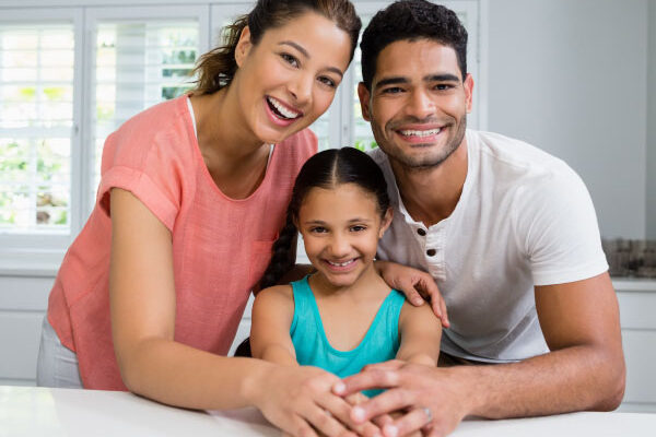 Parents and daughter standing together in kitchen - DG Pinnacle Home Loans - Miami Mortgage Company