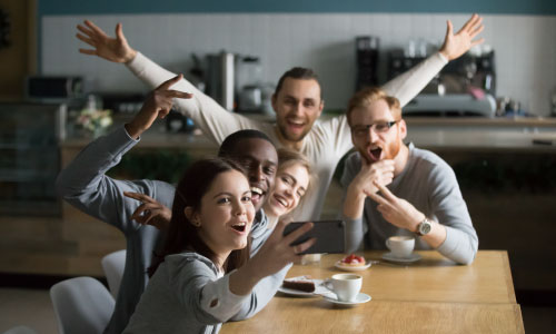 Funny millennial friends taking group selfie at home - DG Pinnaacle Home Loans