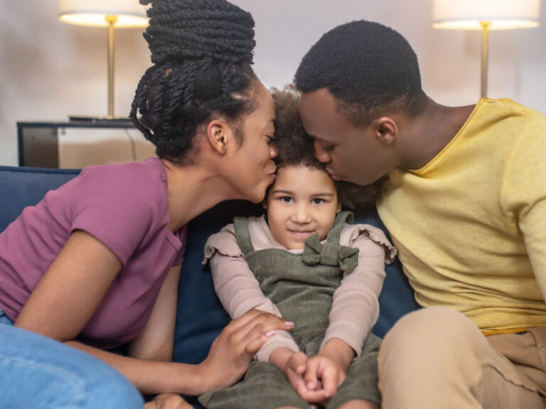 Happy millennial parents with their daughter at home - DG Pinnacle home loans