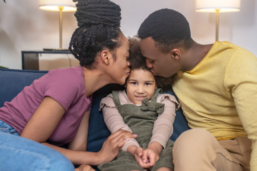 Happy millennial parents with their daughter at home - DG Pinnacle home loans