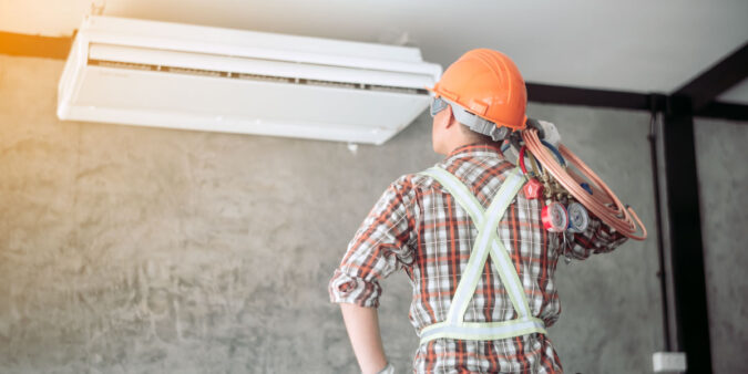 Technician repairing HVAC system - DG Pinnacle Home Loans