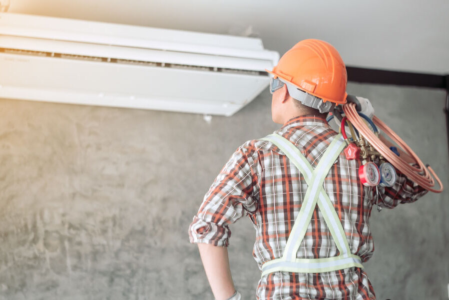 Technician repairing HVAC system - DG Pinnacle Home Loans