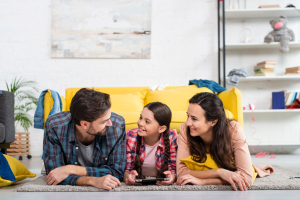 Happy family on living room - DG Pinnacle Home Loans - Miami Mortgage Lender