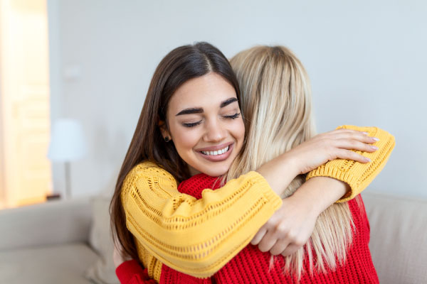 Two happy young girls hugging and celebrating - 4 Tips to Use a Down Payment Gift Correctly - DG Pinnacle Home Loans - Miami Mortgage Lender