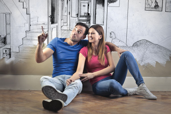 Young couple sitting together and planning decoration for their new home - 5 steps for getting your mortgage pre-approved - DG Pinnacle Home Loans - Miami Mortgage Lender