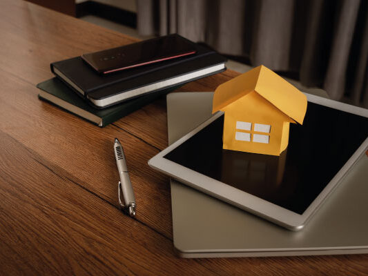 Business concept close up model house and some accessories - MythBusters for the First-Time Homebuyer - DG Pinnacle Home Loans - Miami Mortgage Lender