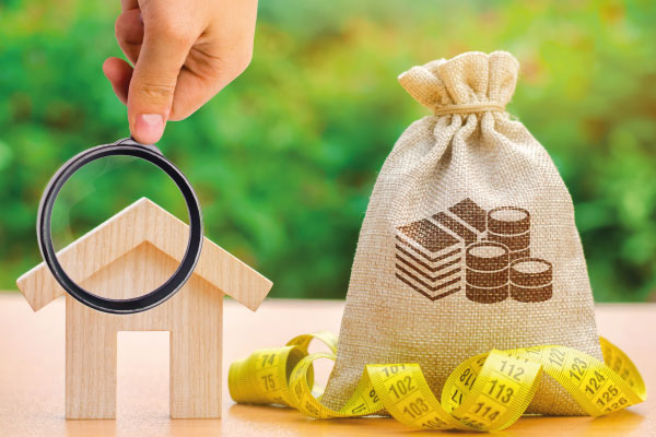 Model house bag with money and tape measure - Home Prices Fell For First Time in 3 Years - DG Pinnacle Home Loans - Miami Mortgage Lender