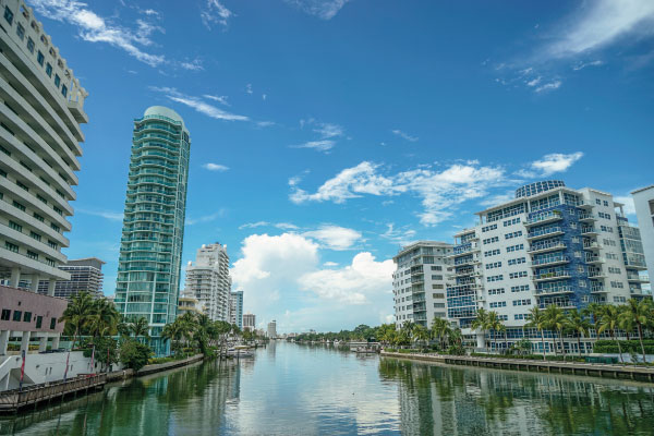 Miami beach view from bridge houses separated by river - 10 Ways to Benefit From The Current Shift in Real Estate - DG Pinnacle Home Loans - Miami Mortgage Lender