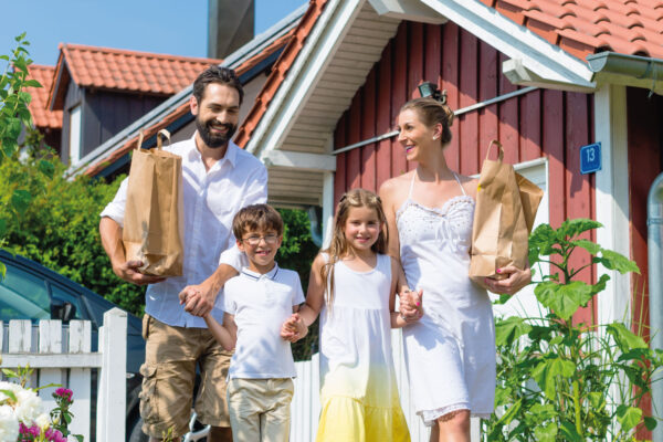 Happy family walking together in the front yard - Home Sweet Texas Home | DG Pinnacle Gome Loans | Mortgage Funding Company