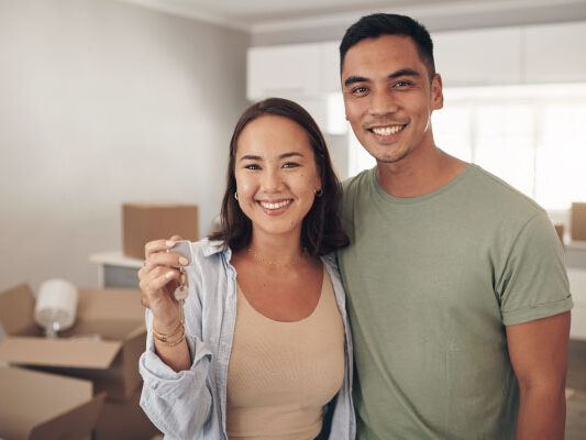 Young happy couple smiling for buying their new house - How Long Does It Take To Close On A House? - DG Pinnacle Home Loans - Miami Mortgage Funding Lending Company