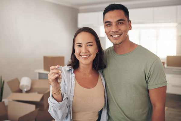 Young happy couple smiling for buying their new house - How Long Does It Take To Close On A House? - DG Pinnacle Home Loans - Miami Mortgage Funding Lending Company