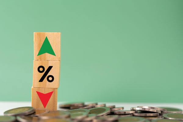 Wooden cube blocks with percentage symbols and coins around - Will Rates Go Down in July 2023? | DG Pinnacle Home Loans | Miami Mortgage Funding Lender