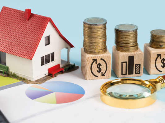 Financing elements with model house and piles of coins - Will Rates Go Down in July 2023? | DG Pinnacle Home Loans | Miami Mortgage Funding Lender