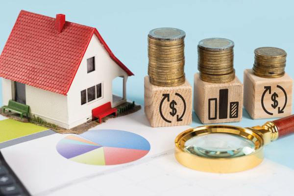 Financing elements with model house and piles of coins - Will Rates Go Down in July 2023? | DG Pinnacle Home Loans | Miami Mortgage Funding Lender