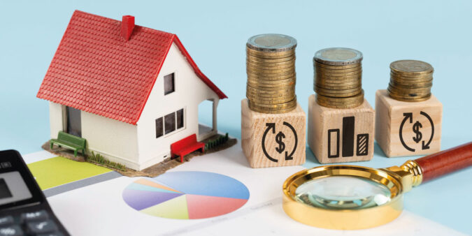 Financing elements with model house and piles of coins - Will Rates Go Down in July 2023? | DG Pinnacle Home Loans | Miami Mortgage Funding Lender