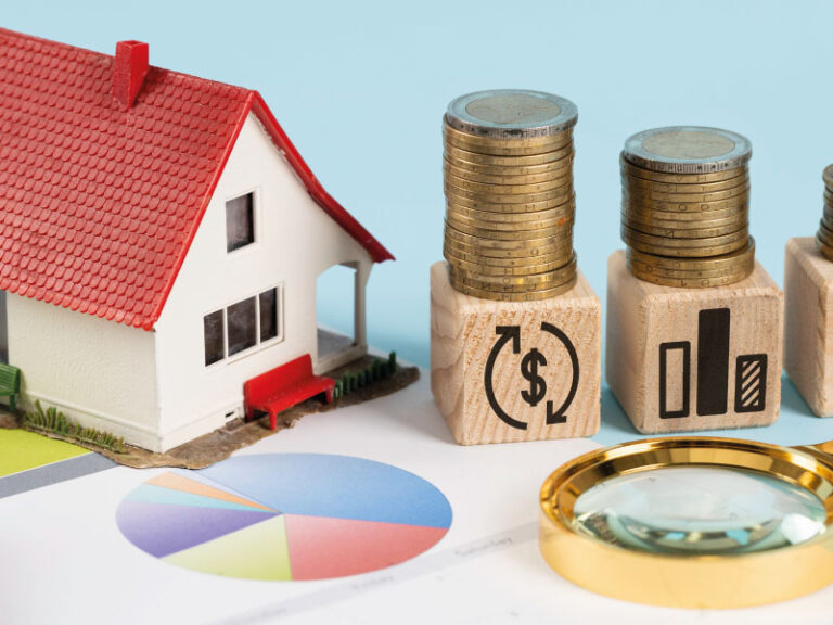Financing elements with model house and piles of coins - Will Rates Go Down in July 2023? | DG Pinnacle Home Loans | Miami Mortgage Funding Lender