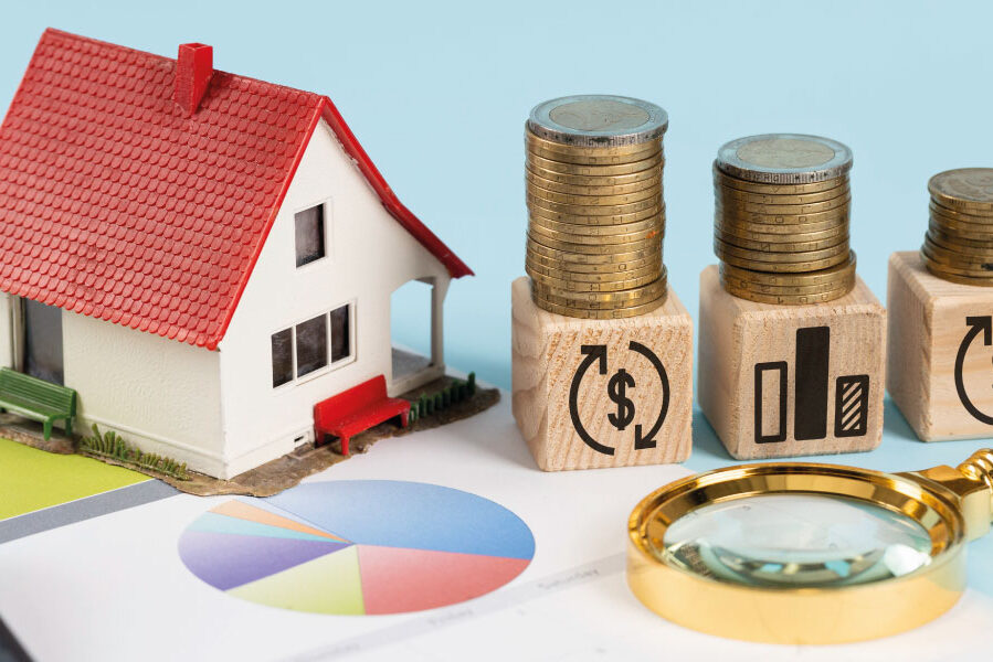 Financing elements with model house and piles of coins - Will Rates Go Down in July 2023? | DG Pinnacle Home Loans | Miami Mortgage Funding Lender