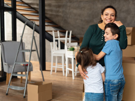 Young latin mother with her children moving to their new home - Florida First Time Homebuyer Programs | DG Pinnacle Home Loans | Mortgage Lender Funding Company