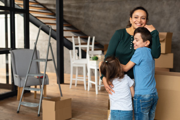 Young latin mother with her children moving to their new home - Florida First Time Homebuyer Programs | DG Pinnacle Home Loans | Mortgage Lender Funding Company