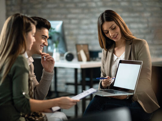 Female mortgage officer at office talking to a couple - What is a Closed-End Second Mortgage | DG Pinnacle Home Loans | Miami Mortgage Lender