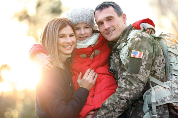 Happy soldier with family in the park - VA Home Loan Benefits | DG Pinnacle Home Loans | Miami Mortgage Lender