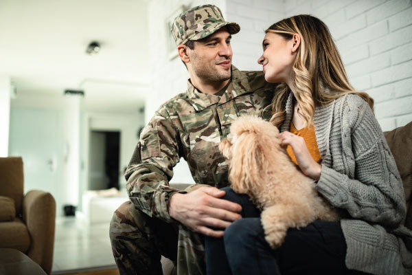Young veteran talking to his wife - VA Home Loan Benefits | DG Pinnacle Home Loans | Miami Mortgage Lender