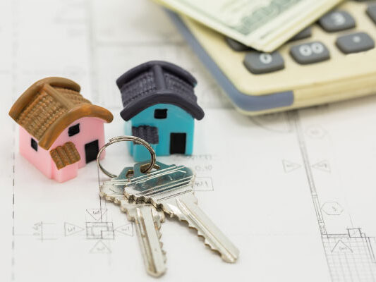 Model houses keys and calculator with dollar bills | What is an FHA cash-out refinance | DG Pinnacle Home Loans - Miami Mortgage Lender